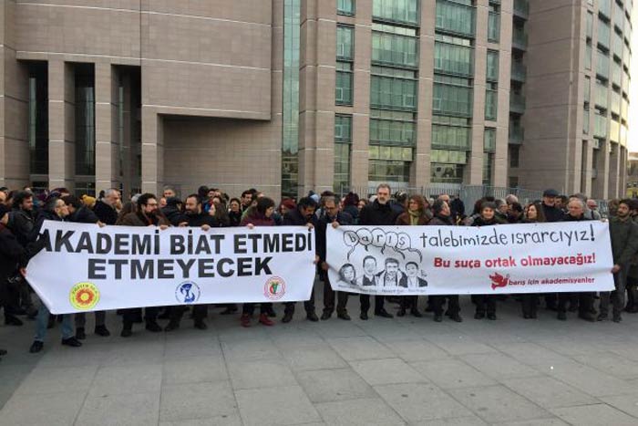 Protesters mark the opening of trials against Turkish academics.
