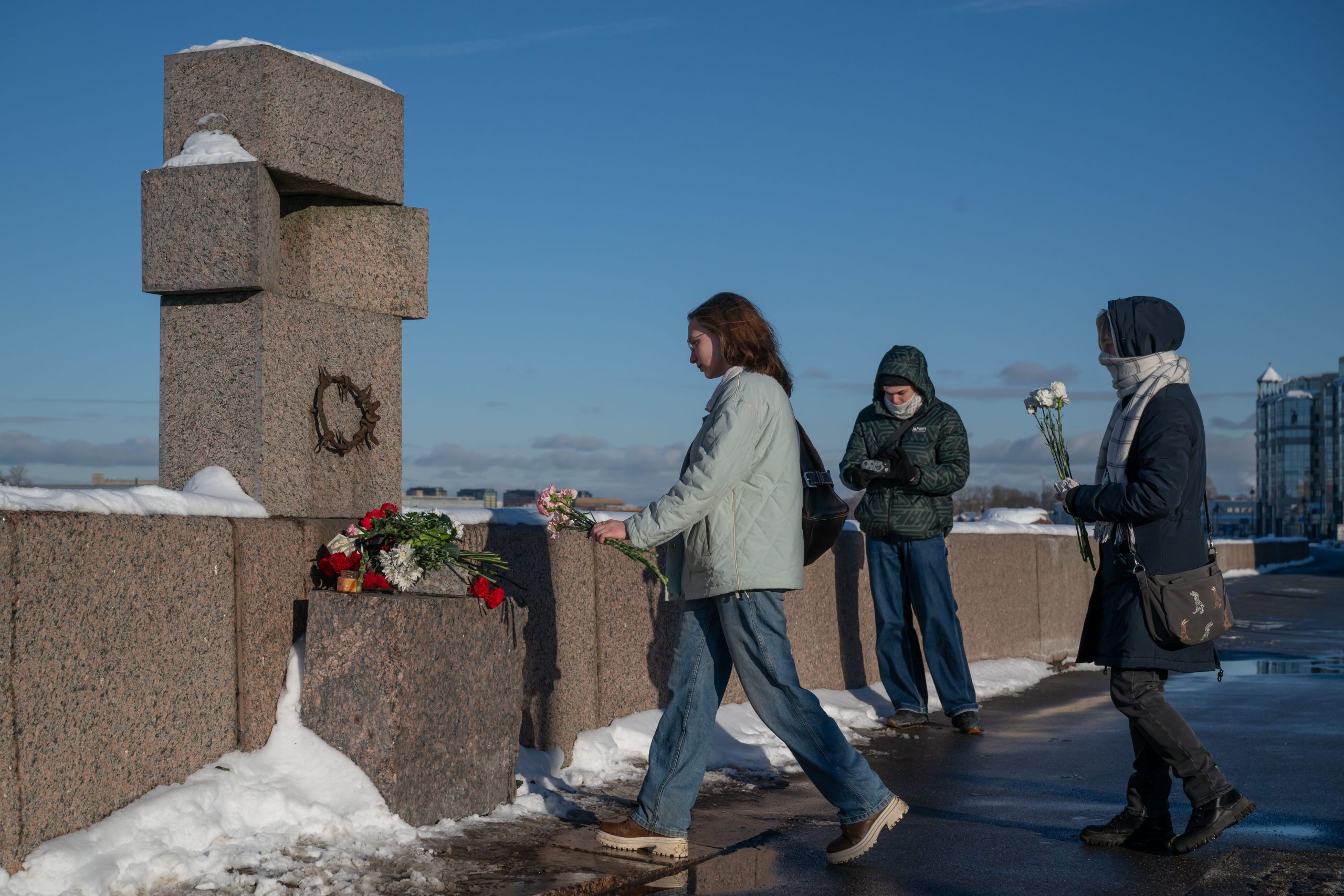 Women lay flowers in memory of Russian opposition leader Alexei Navalny a year after his death at the Memorial to the Victims of Political Repressions in St. Petersburg.