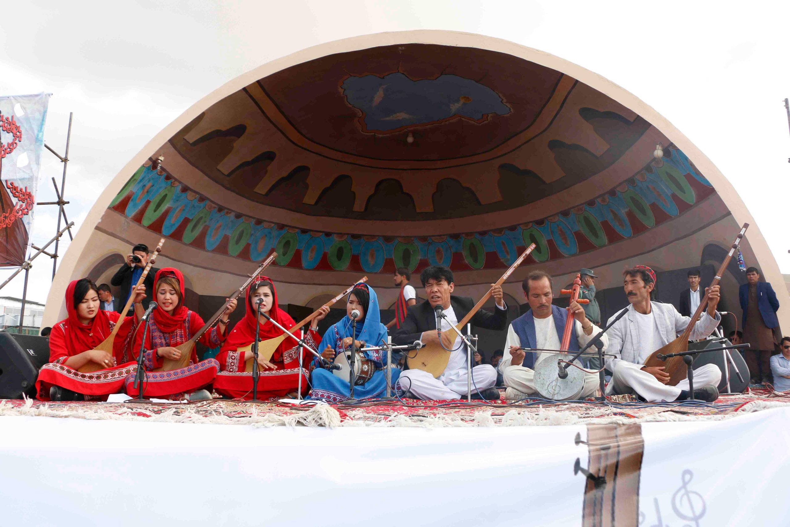 Afghans play the dambora at a music festival in Bamyan province in 2017