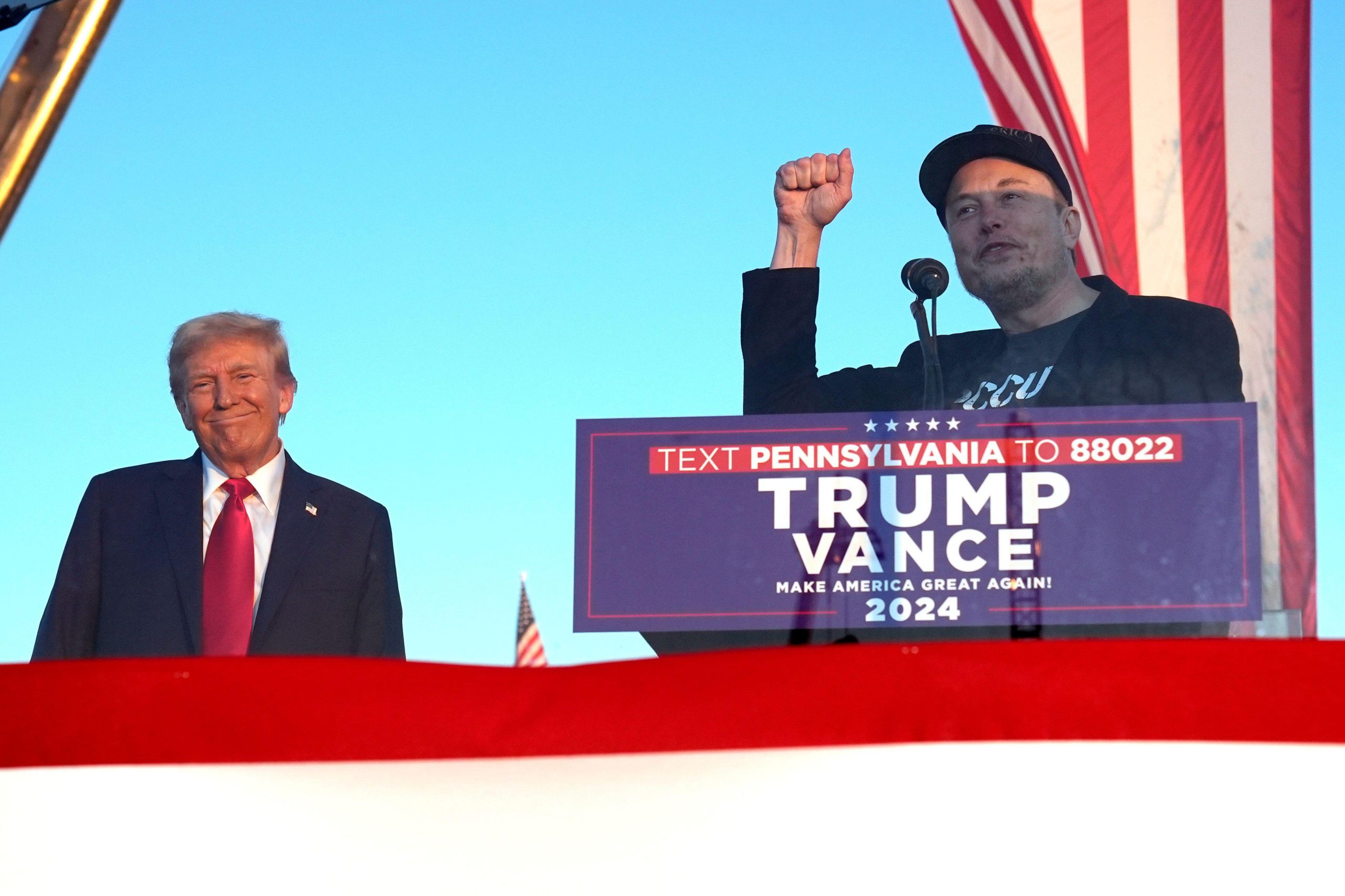 Tesla and SpaceX CEO Elon Musk speaks as President Donald Trump listens at a campaign event